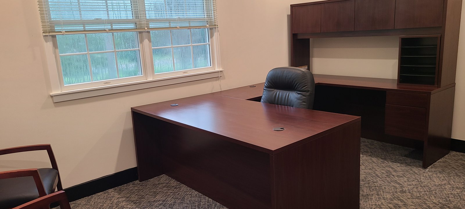 Executive office with large desk and storage wall